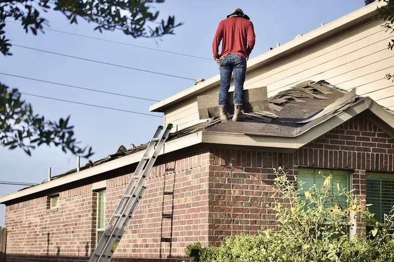 Professional roofer working on a residential roof in Poplar Springs